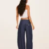 Jeans de cintura baixa com corte balão torcido – Calças