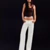 Jeans de ganga largos de cintura baixa com tachas – Calças