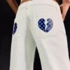 Jeans de ganga largos de cintura baixa com tachas – Calças