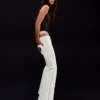 Jeans de ganga largos de cintura baixa com tachas – Calças